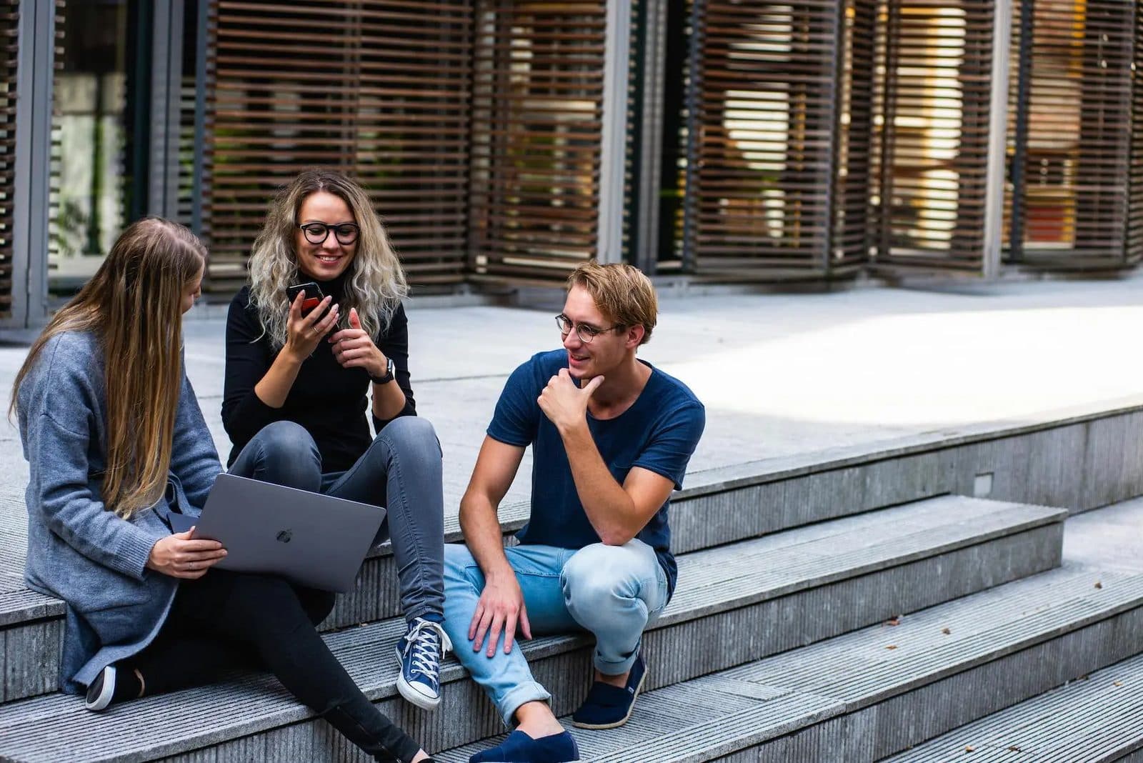 Students sitting together on campus steps