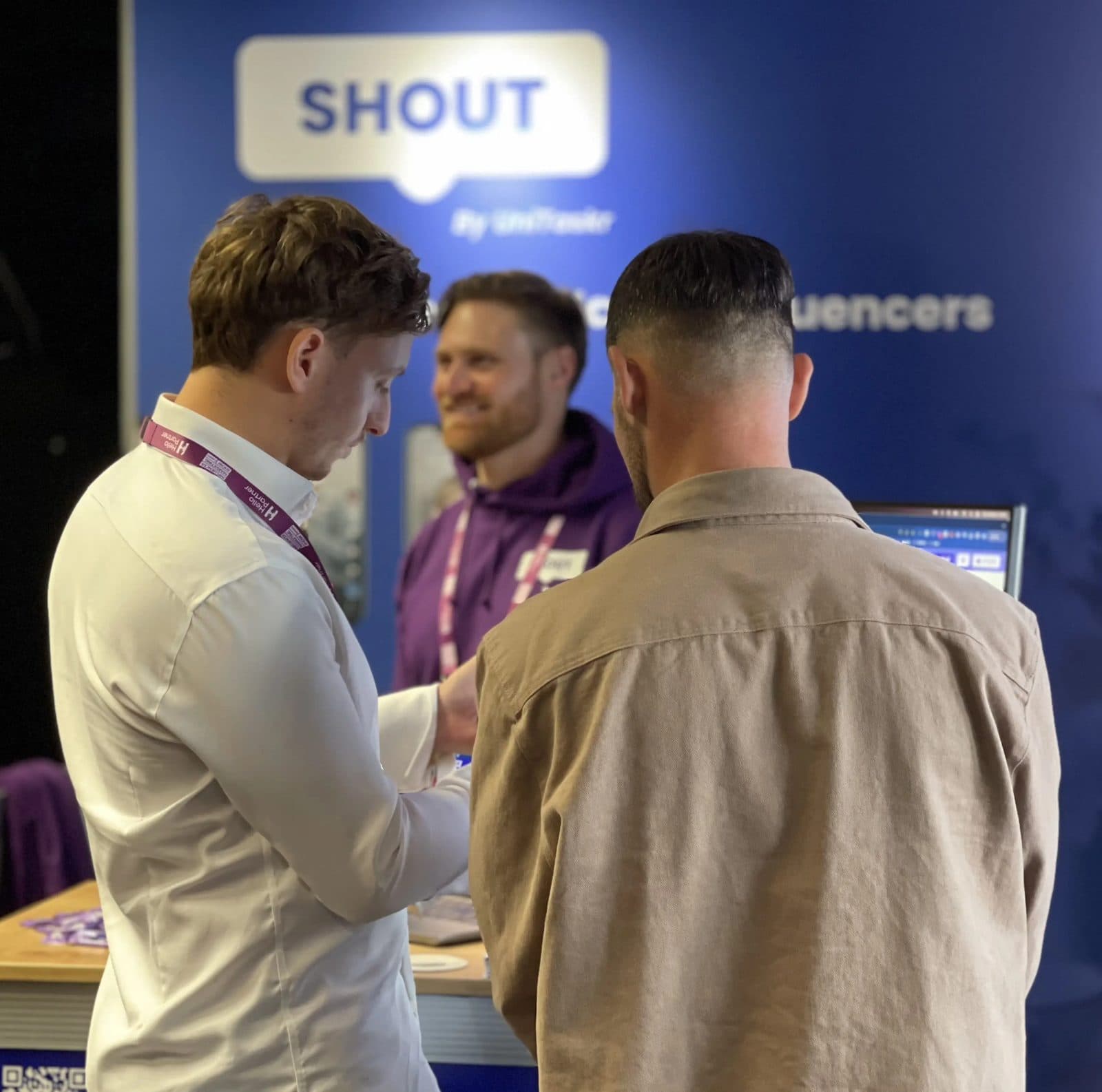 Students chatting to visitors at a SHOUT event stand