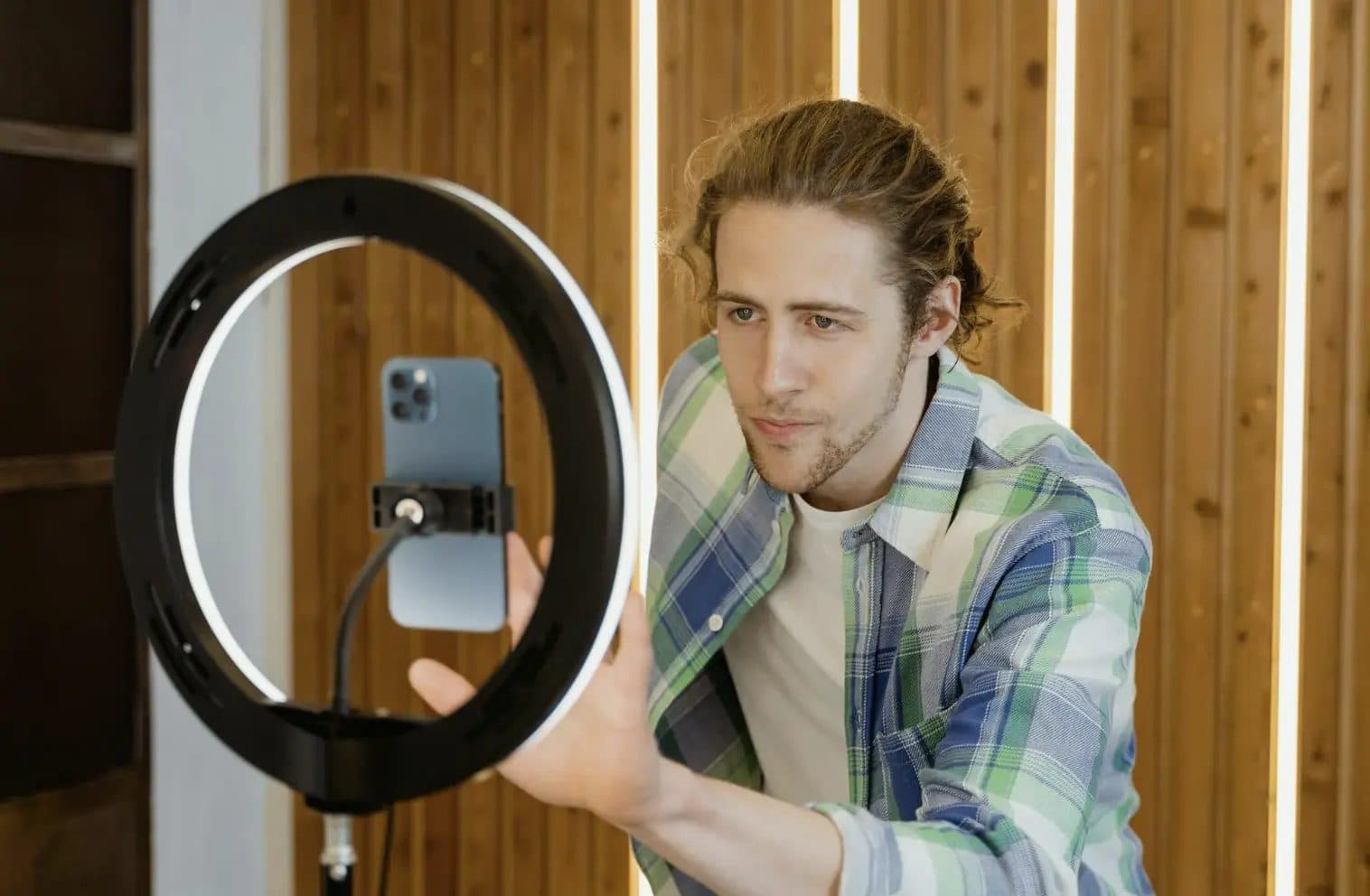 Student creator setting up a phone on a ring light