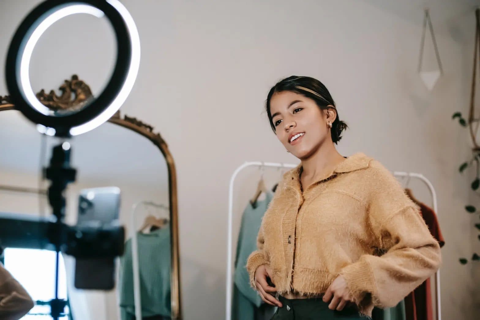 Student influencer filming a fashion video with a ring light